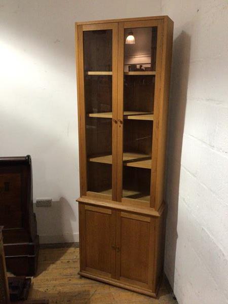 A Hans Elleflaadt (c.1948-89), oak standing corner cabinet, the upper section fitted a pair of