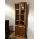 A Hans Elleflaadt (c.1948-89), oak standing corner cabinet, the upper section fitted a pair of