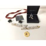 A collection of costume jewellery including a paste pearl bracelet (18cm), a polished stone