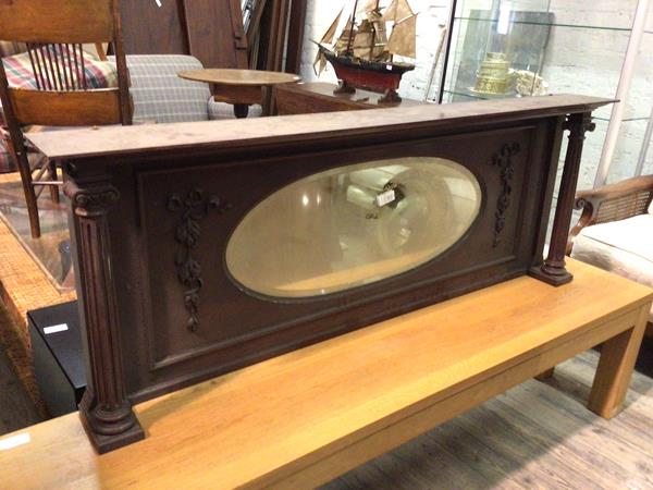 A sideboard superstructure, with oval mirror flanked by ribbon and foliate decoration, the ledge