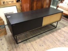 A Woud Virka low oak and ebonised sideboard, fitted two sliding doors enclosing shelved on