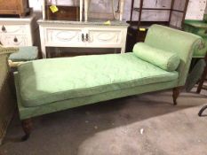 A late 19thc/early 20thc daybed, in green floral damask fabric, with rolled back bolster cushion, on