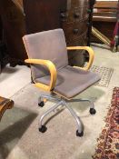 A modern Ikea office chair, the bent beech frame with grey upholstered back and seat pads,