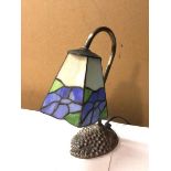 A Tiffany style desk lamp with faceted glass shade, on leaf and fruit base (27cm)