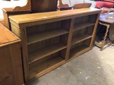 An Edwardian open bookcase, the rectangular moulded top above a plain frieze, fitted two sets of