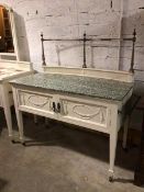 A washstand with metal galleried rail to back, above a concave ledge, with marble top above a pair