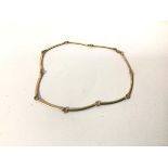 A 9ct gold necklace, comprised of curved bars and rings, with lobster claw clasp (15.95g) (18cm)