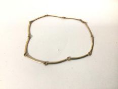 A 9ct gold necklace, comprised of curved bars and rings, with lobster claw clasp (15.95g) (18cm)