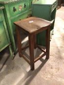 An early 20thc oak stool with square saddle seat, on square supports united by box stretcher (58cm x