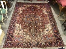 A Heriz rug, with large geometric medallion with overall floral and naturalistic motif within a