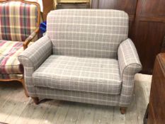 A Next love seat, with rolled arms and seat cushion in plaid grey upholstery, on turned supports (