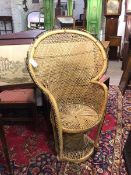 A wicker peacock style chair with fan back on waisted support (170cm x 80cm x 50cm)