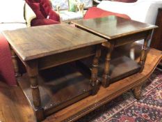 A pair of oak lamp tables, the square tops with moulded edges, on turned supports united by