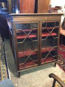 An Edwardian mahogany bookcase, the rectangular top with moulded edge above two glazed doors with