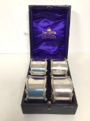 A set of four Edwardian London silver Mappin & Webb napkin rings, two inscribed, I and II, the other