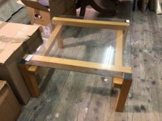 A contemporary coffee table with square glass top on beech frame with straight square supports (35cm