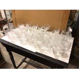 A large quantity of glassware including cut glass wine glasses, sherry glasses, fruit bowls,