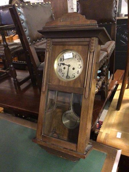 A 1930s/40s wall clock, the metal dial with arabic numerals, with glazed lower half (82cm x 38cm x