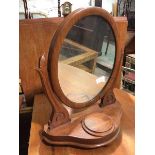 A first half of 20thc dressing table mirror, the oval glass on foliate style supports, on an