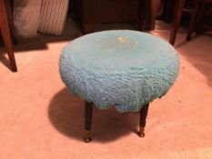 A 1960s style footstool with later blue upholstery, on outswept tapering supports terminating in