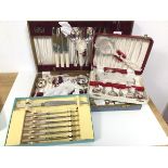 A collection of cutlery, two in original canteens, one marked The Hampshire Canteen, with knives,