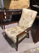 A Parker Knoll armchair, with floral upholstered backs and seat cushion, with sprung seat, on