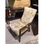 A Parker Knoll armchair, with floral upholstered backs and seat cushion, with sprung seat, on