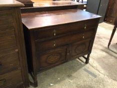 A 1920s oak side cabinet, the ledge back with bead moulding above a rectangular top and