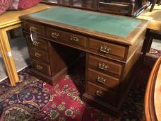 A 1930s/40s pedestal desk, the rectangular top with a laminate writing surface above three frieze