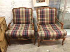 A pair of modern Louis XV inspired bergeres with plaid upholstered backs and seat cushions, on