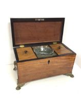 A Regency mahogany tea caddy, the interior with original tea cannister lids (lacking lead liners and