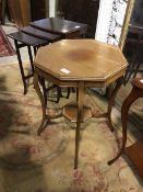 An Edwardian mahogany centre table, the octagonal crossbanded top above a plain frieze with scroll