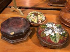 A group of three footstools, including a circular footstool with floral grospoint top and another