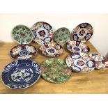 A collection of seven Imari dishes, two dishes with a light green ground and floral and animal
