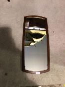 A mid century wall mirror, of rounded rectangular form with teak frame (78cm x 36cm)