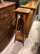 An Edwardian plant stand with square top above a pierced apron, on angled supports united by