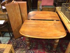 A late Victorian mahogany extending dining table, the moulded top with two additional leaves, on