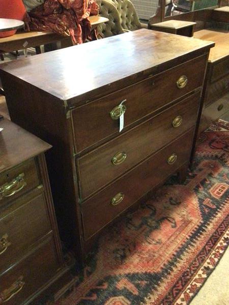 An early 19thc mahogany chest of drawers, with later handles, the rectangular top above three