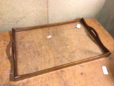 A drinks tray with mahogany raised edge and pierced handles with glass base (50cm x 62cm x 43cm)