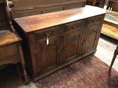 An oak sideboard, with rectangular top above three frieze drawers and three cabinet doors