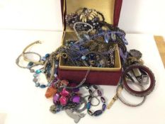 A quantity of costume jewellery including necklaces, bangles, badges, watches etc. (a lot)