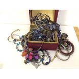 A quantity of costume jewellery including necklaces, bangles, badges, watches etc. (a lot)