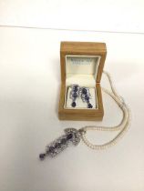 A pearl necklace with silver pendant with tanzanite and paste stones, with matching earrings, marked