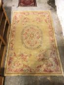 A Savonnerie rug with central oval floral medallion with floral design to corners and border (