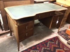 A 1930s/40s desk, the top with an inverted serpentine front, above a single frieze drawer, flanked