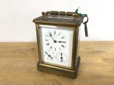 A brass and glass carriage clock with glass to top and four sides, the face with roman numerals to