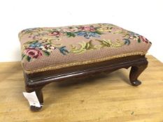 A 1930s/40s footstool with tapestry floral top above a moulded apron, on cabriole supports (20cm x