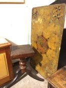 A 1920s dining table with faux marble top with heraldic decoration, with unassociated base (78cm x