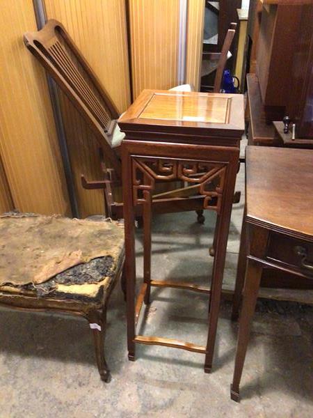 A Chinese plant stand with chanelled square top above a pierced apron, on straight supports united