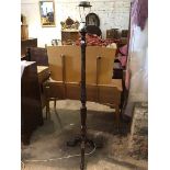 A 19thc style floor lamp with reeded and carved stem on tripod support ending in ball and claw